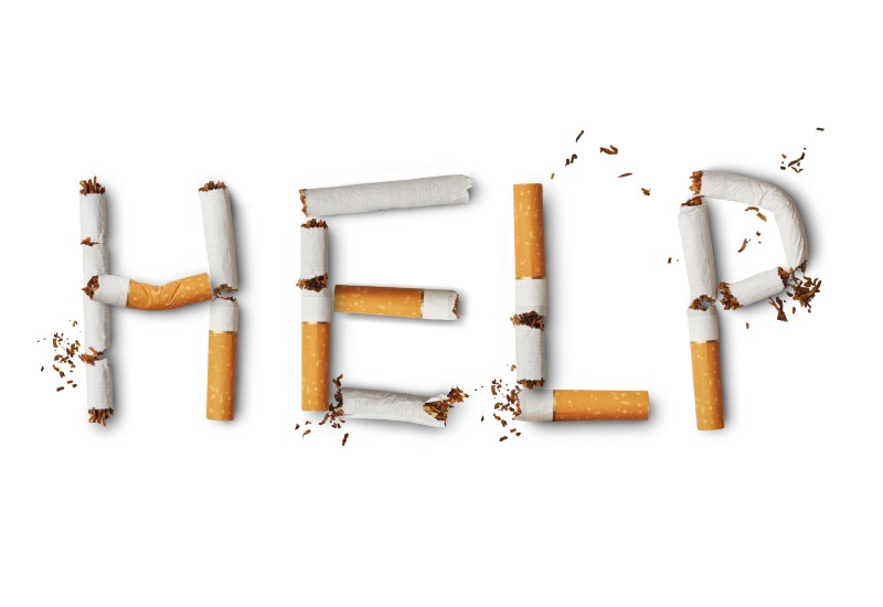 The word &#039;Help&#039; written in broken cigarettes on a white background